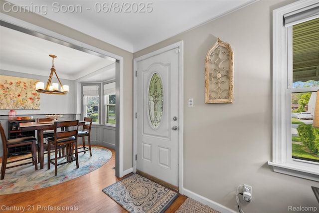 22601 Colony St, Saint Clair Shores, MI 48080 - foyer entrance with baseboards, wood finished floors, and a chandelier