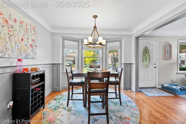 22601 Colony St, Saint Clair Shores, MI 48080 - dining area with a chandelier, a wainscoted wall, light wood-type flooring, and a decorative wall