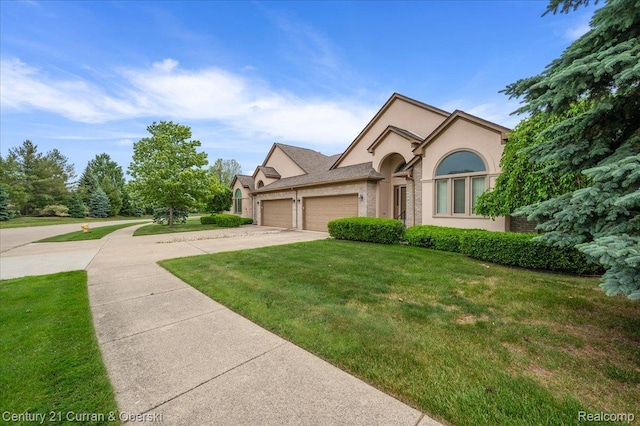 52179 Sawmill Creek Dr, Macomb, MI 48042 - view of front of house featuring a garage, concrete driveway, a front lawn, and stucco siding