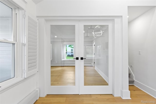 5164 Plymouth Rd, Ann Arbor, MI 48105 - detailed view of a baseboard heating unit, french doors, and wood finished floors