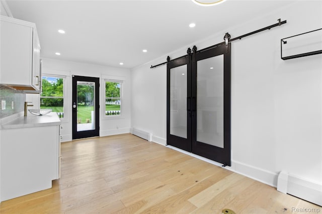 5164 Plymouth Rd, Ann Arbor, MI 48105 - entryway featuring a barn door, light wood finished floors, and recessed lighting