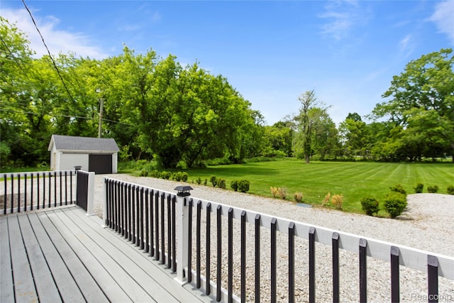 5164 Plymouth Rd, Ann Arbor, MI 48105 - wooden deck with an outbuilding, a garage, view of scattered trees, and a lawn
