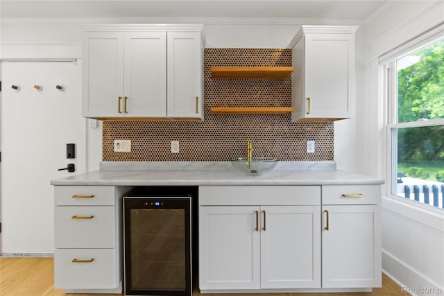 5164 Plymouth Rd, Ann Arbor, MI 48105 - kitchen with wine cooler, open shelves, white cabinets, backsplash, and light stone counters