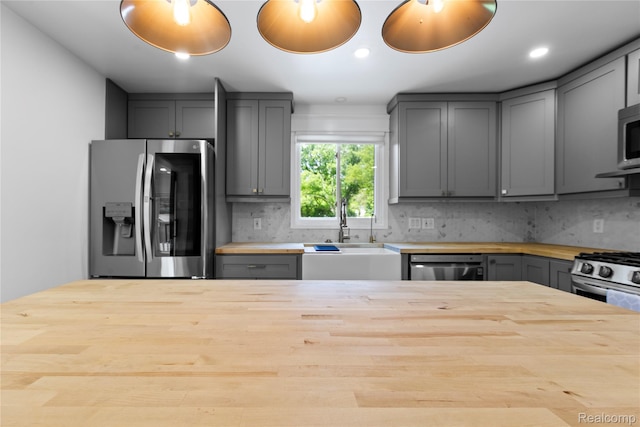 5164 Plymouth Rd, Ann Arbor, MI 48105 - kitchen with butcher block counters, appliances with stainless steel finishes, gray cabinetry, tasteful backsplash, and recessed lighting