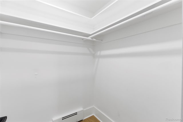 5164 Plymouth Rd, Ann Arbor, MI 48105 - spacious closet featuring a baseboard radiator and wood finished floors