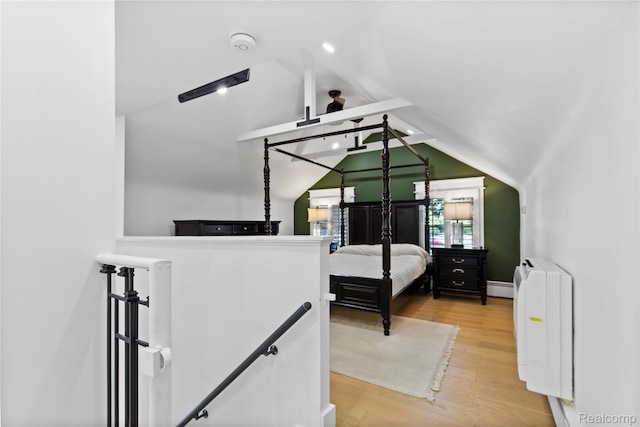5164 Plymouth Rd, Ann Arbor, MI 48105 - bedroom with vaulted ceiling, a baseboard radiator, and wood finished floors