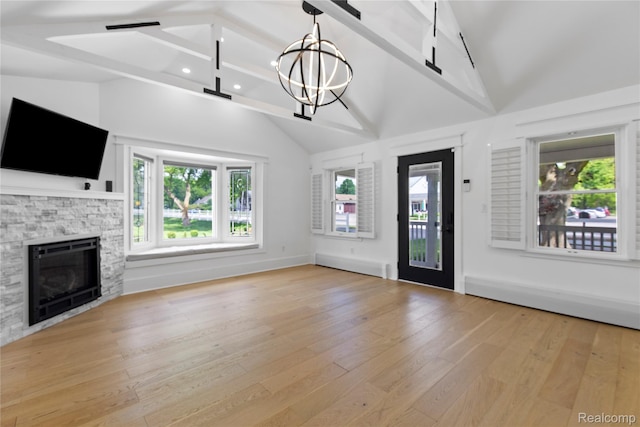 5164 Plymouth Rd, Ann Arbor, MI 48105 - unfurnished living room featuring wood finished floors, a stone fireplace, a chandelier, recessed lighting, and beamed ceiling