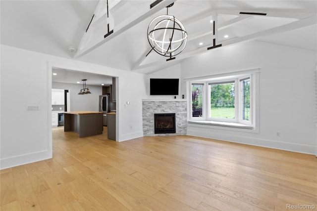 5164 Plymouth Rd, Ann Arbor, MI 48105 - unfurnished living room with light wood-style flooring, beam ceiling, recessed lighting, a fireplace, and a chandelier