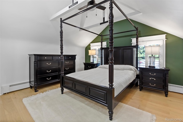 5164 Plymouth Rd, Ann Arbor, MI 48105 - bedroom with a baseboard heating unit, light wood-style floors, lofted ceiling, and multiple windows