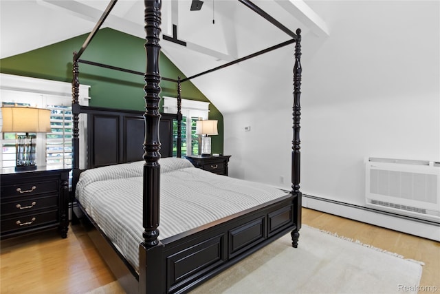 5164 Plymouth Rd, Ann Arbor, MI 48105 - bedroom featuring wood finished floors, vaulted ceiling, and a baseboard heating unit