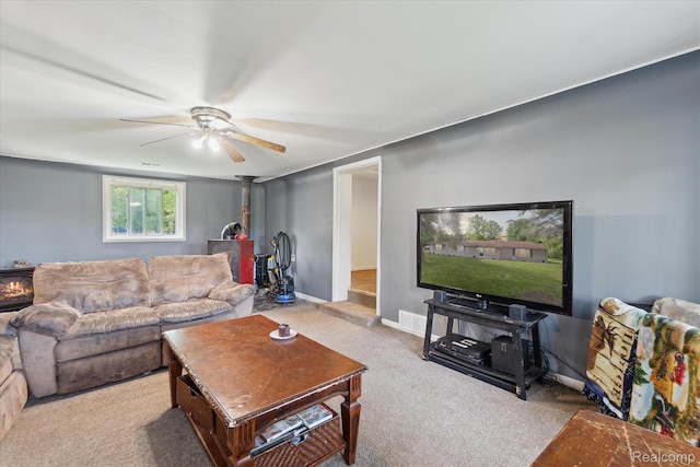 4828 Rathbun Rd, Birch Run, MI 48415 - living room with a wood stove, carpet, a ceiling fan, and baseboards