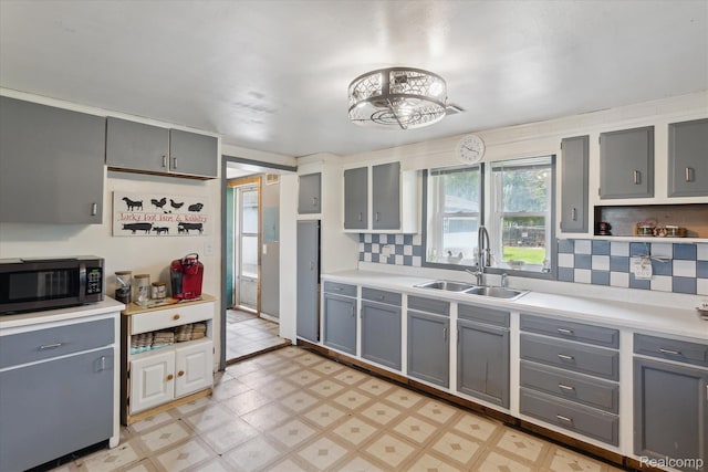 4828 Rathbun Rd, Birch Run, MI 48415 - kitchen featuring black microwave, a sink, gray cabinets, and light flooring