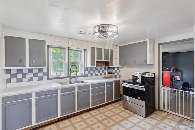 4828 Rathbun Rd, Birch Run, MI 48415 - kitchen featuring stainless steel electric stove, gray cabinets, a sink, light floors, and tasteful backsplash