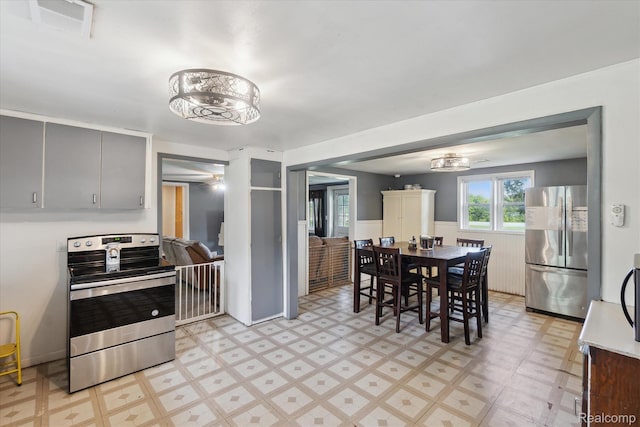 4828 Rathbun Rd, Birch Run, MI 48415 - dining area with light flooring and a wainscoted wall