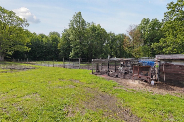 4828 Rathbun Rd, Birch Run, MI 48415 - view of yard featuring exterior structure, an outbuilding, and a wooded view