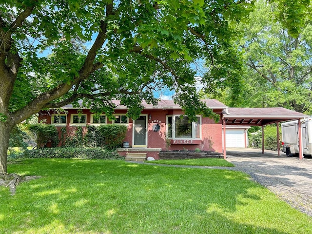 2069 Kenwood Dr, Flint, MI 48532 - ranch-style home with a carport, a front lawn, asphalt driveway, a shingled roof, and brick siding
