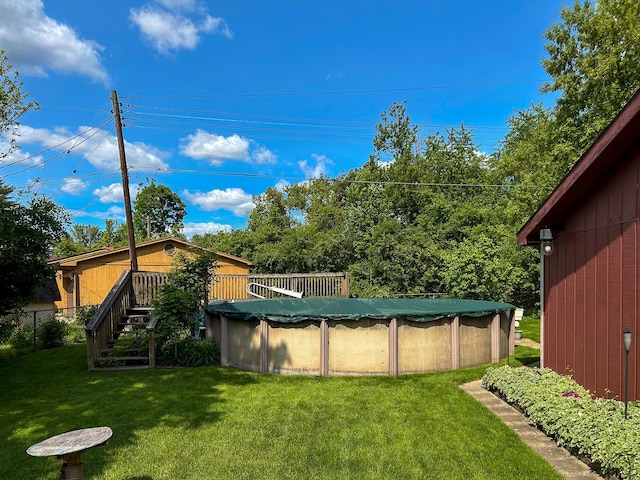 2069 Kenwood Dr, Flint, MI 48532 - view of grassy yard featuring a wooden deck, stairs, and a covered pool