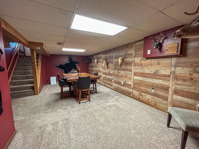 2069 Kenwood Dr, Flint, MI 48532 - carpeted dining room with a drop ceiling, wooden walls, and stairway
