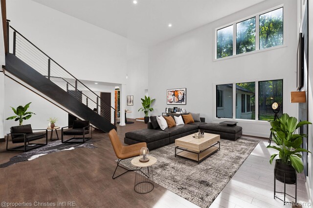 5080 Tootmoor Rd, Bloomfield Hills, MI 48302 - living room with a towering ceiling, stairs, wood finished floors, and recessed lighting