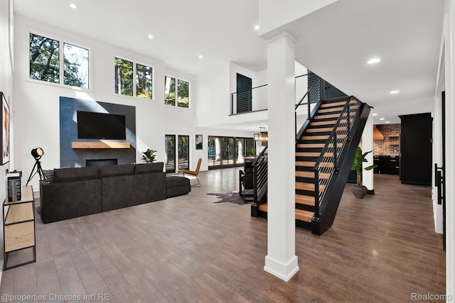 5080 Tootmoor Rd, Bloomfield Hills, MI 48302 - living area featuring stairway, wood finished floors, a fireplace, recessed lighting, and a towering ceiling