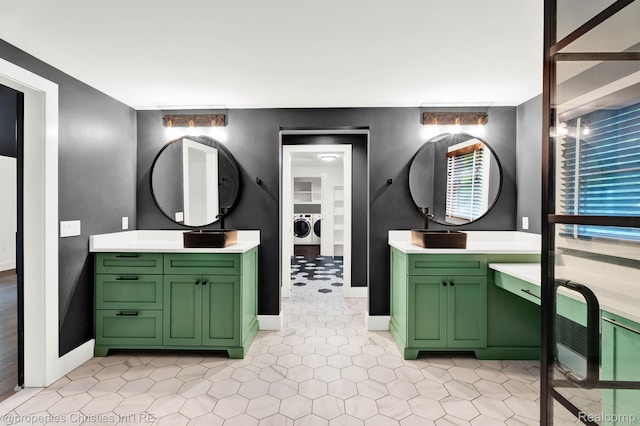 5080 Tootmoor Rd, Bloomfield Hills, MI 48302 - full bathroom with washer and dryer, two vanities, tile patterned flooring, and baseboards