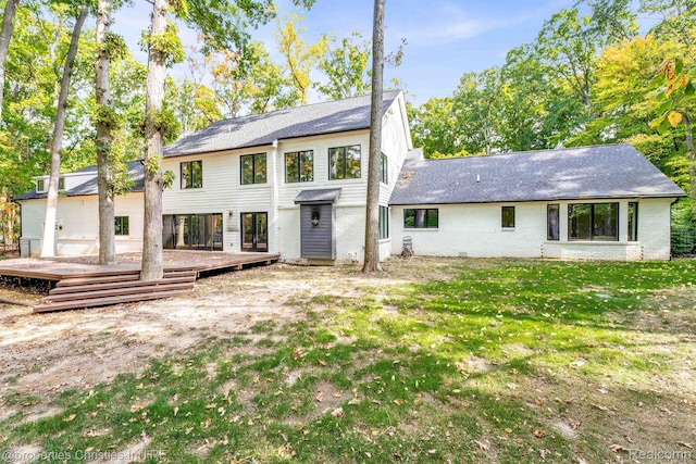 5080 Tootmoor Rd, Bloomfield Hills, MI 48302 - back of property with a wooden deck, brick siding, a shingled roof, and a lawn