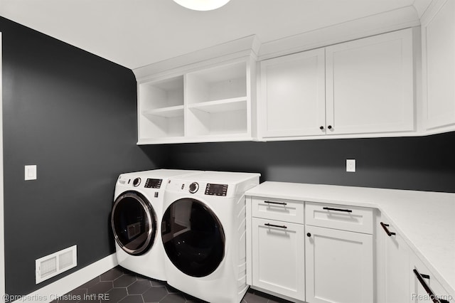 5080 Tootmoor Rd, Bloomfield Hills, MI 48302 - laundry room with cabinet space, separate washer and dryer, dark tile patterned flooring, and baseboards