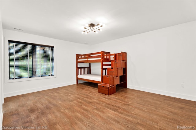 5080 Tootmoor Rd, Bloomfield Hills, MI 48302 - unfurnished bedroom with wood finished floors and baseboards