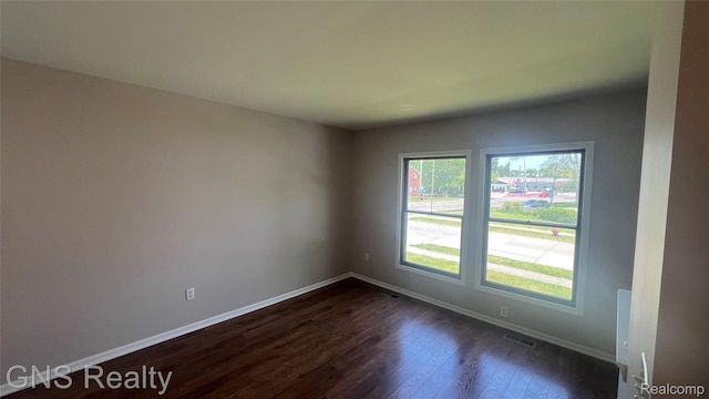 604 Millard Ave, Royal Oak, MI 48073 - empty room with dark wood-style flooring and baseboards