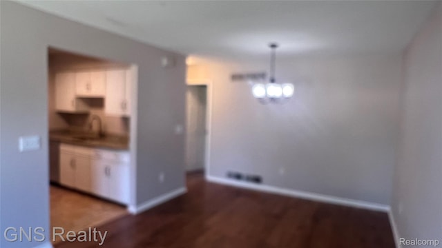604 Millard Ave, Royal Oak, MI 48073 - unfurnished dining area featuring wood finished floors, baseboards, and a sink