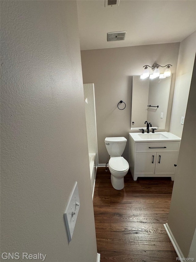 604 Millard Ave, Royal Oak, MI 48073 - bathroom with vanity, wood finished floors, toilet, and baseboards