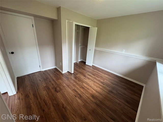 604 Millard Ave, Royal Oak, MI 48073 - unfurnished bedroom featuring dark wood-style floors, baseboards, and a closet