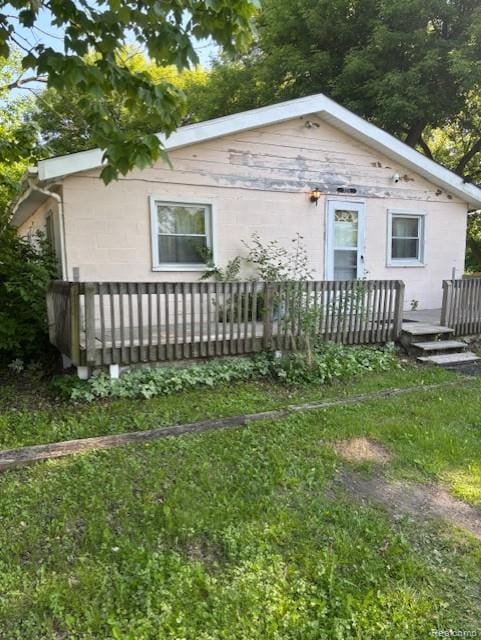 3231 Parker St, Port Huron, MI 48060 - view of property exterior with a deck and concrete block siding