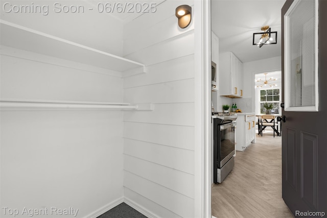 1703 N Blair Ave, Royal Oak, MI 48067 - kitchen featuring stainless steel electric range, white cabinets, light countertops, and light wood finished floors