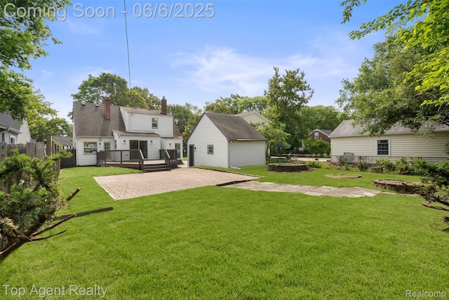 1703 N Blair Ave, Royal Oak, MI 48067 - rear view of property with a wooden deck, a patio, an outdoor structure, and a chimney