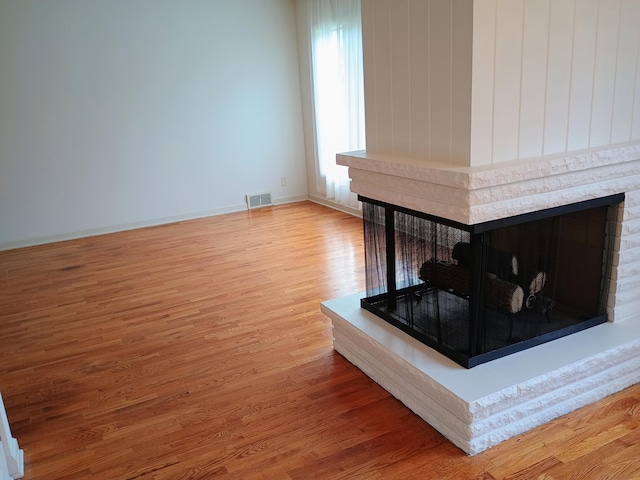 1635 Woodside Dr, East Lansing, MI 48823 - detailed view of a multi sided fireplace and wood finished floors