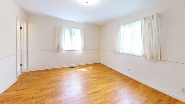 1635 Woodside Dr, East Lansing, MI 48823 - spare room with light wood-type flooring and baseboards