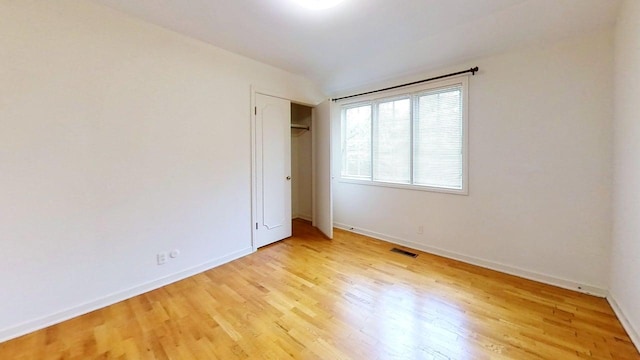 1635 Woodside Dr, East Lansing, MI 48823 - unfurnished bedroom featuring light wood-type flooring, baseboards, and a closet