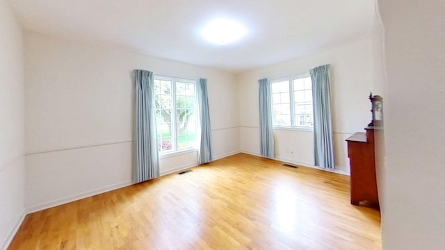 1635 Woodside Dr, East Lansing, MI 48823 - empty room featuring wood finished floors and baseboards
