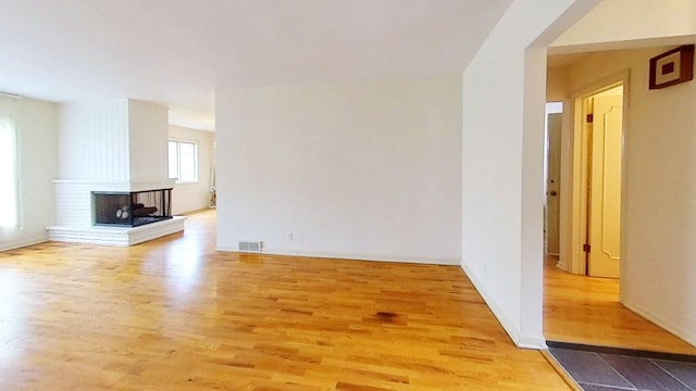 1635 Woodside Dr, East Lansing, MI 48823 - unfurnished living room with wood finished floors and baseboards