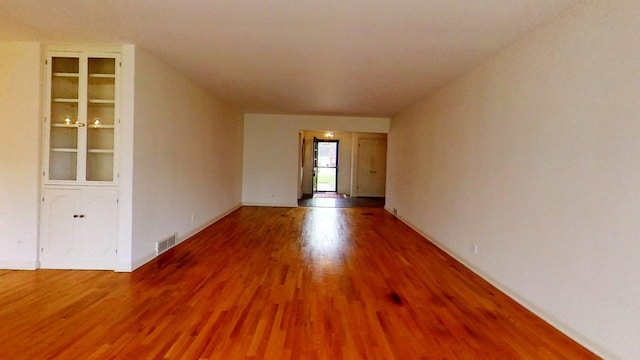 1635 Woodside Dr, East Lansing, MI 48823 - empty room featuring wood finished floors and baseboards