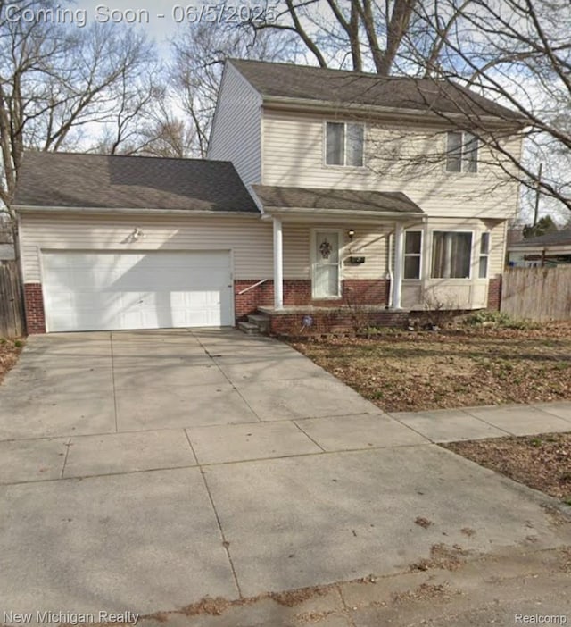 434 W Bernhard Ave, Hazel Park, MI 48030 - traditional-style home featuring brick siding, a garage, concrete driveway, and a porch