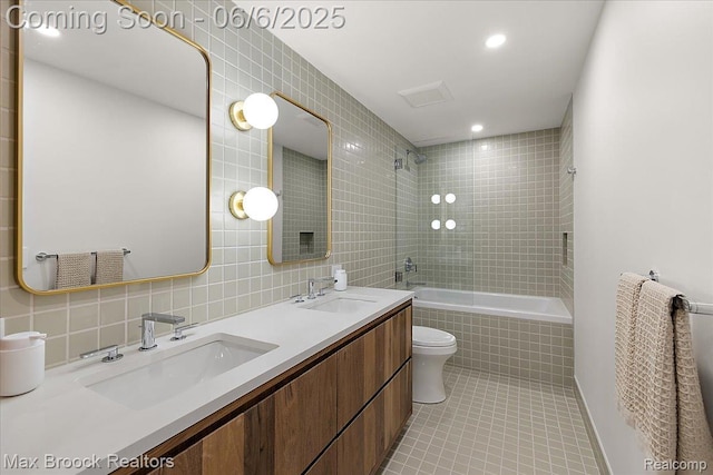 4340 Charing Cross Rd, Bloomfield Hills, MI 48304 - full bath featuring tile patterned flooring, tiled shower / bath, tile walls, double vanity, and toilet