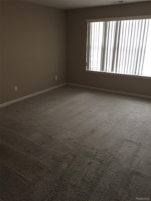 49225 W Woods Dr Unit 20, Utica, MI 48317 - empty room featuring carpet and baseboards