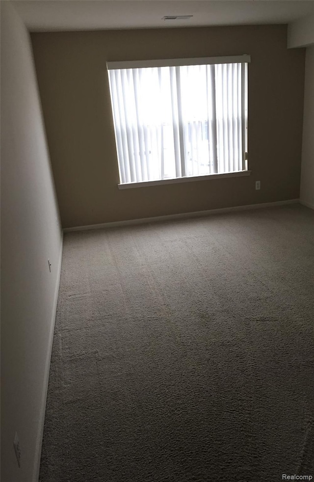 49225 W Woods Dr Unit 20, Utica, MI 48317 - carpeted empty room featuring baseboards