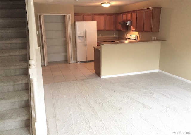 49225 W Woods Dr Unit 20, Utica, MI 48317 - kitchen featuring white fridge with ice dispenser, range, under cabinet range hood, a peninsula, and light carpet