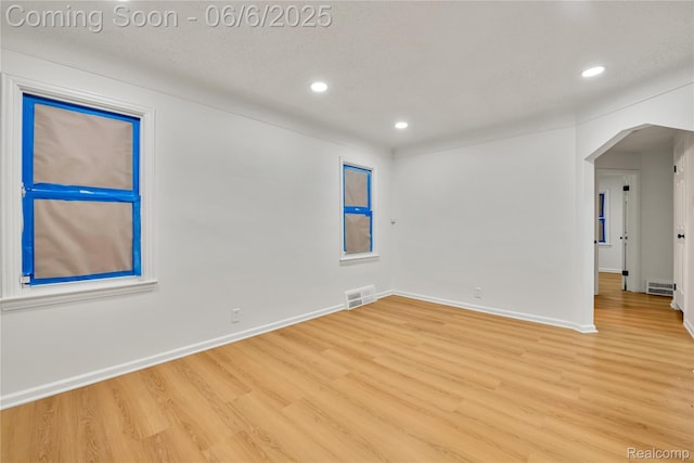 9248 Manor St, Detroit, MI 48204 - spare room featuring arched walkways, wood finished floors, recessed lighting, and baseboards