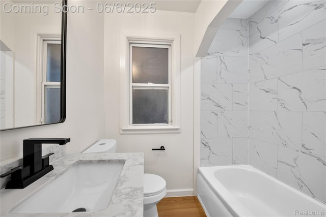9248 Manor St, Detroit, MI 48204 - bathroom with toilet, baseboards, vanity, wood finished floors, and washtub / shower combination