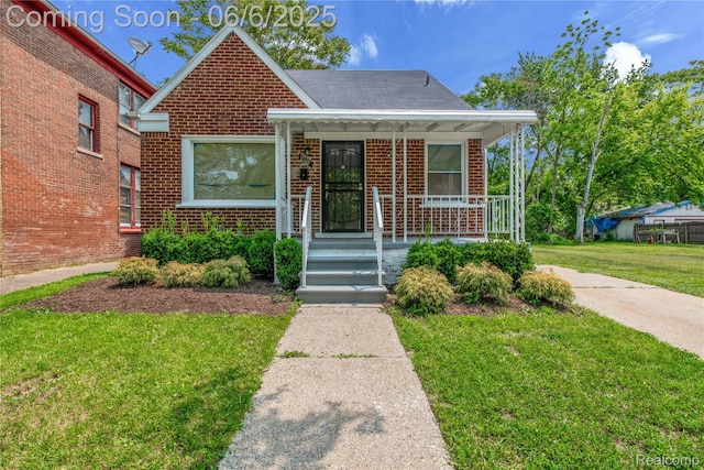 9248 Manor St, Detroit, MI 48204 - bungalow-style home featuring brick siding, a front yard, and covered porch