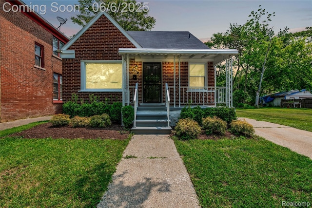 9248 Manor St, Detroit, MI 48204 - bungalow-style home featuring brick siding, a front lawn, and a porch